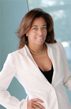 A woman in white jacket posing for the camera.