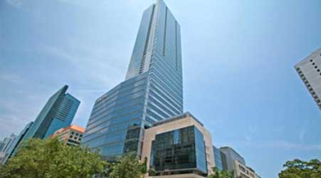 A tall building with many windows in the background.